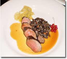 Pan Roasted Lamb Medallions with Wild Rice, Melted Leeks and Lamb Reduction