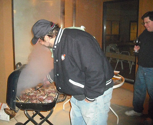 Rick Dayan grilling lamb in the courtyard